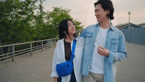 Young Asian couple bonding, talking and walking relaxing in the city park - Powered by Shutterstock - Get 15% off with code: PIKWIZARD15