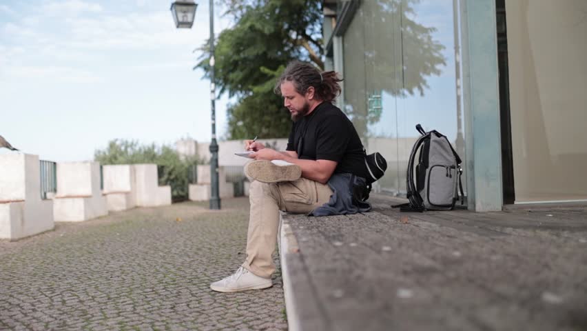Artist sketching outdoors in urban setting