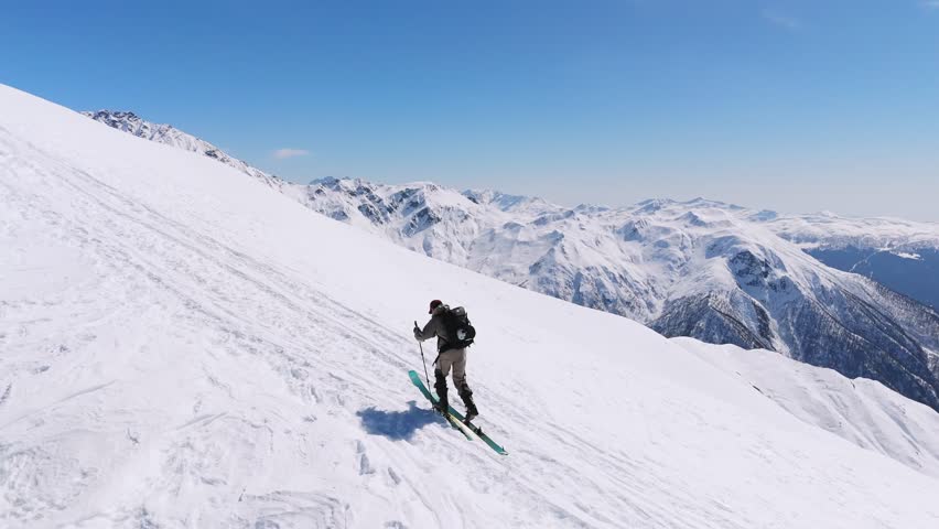 Ski Mountaineer Climbing On Snowy Caucasus Mountains In Svaneti Region, Georgia. drone shot