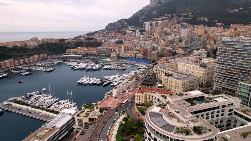 Aerial views of Monte Carlos stunning coastline and cityscape. This high quality drone footage captures vibrant streets, luxurious yachts, and iconic architecture for travel and lifestyle projects.
