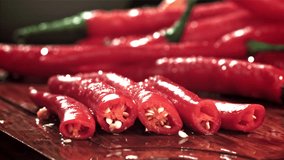 The knife cuts the chili pepper with a splash of water. Filmed on a high-speed camera at 1000 fps. High quality FullHD footage - Powered by Shutterstock - Get 15% off with code: PIKWIZARD15