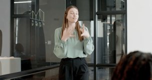Lifestyle videos indoor of people doing activities at office, presenting data, businesswoman explaining graphs to colleagues in modern office. giving presentations, half body, with hand gestures - Powered by Shutterstock - Get 15% off with code: PIKWIZARD15