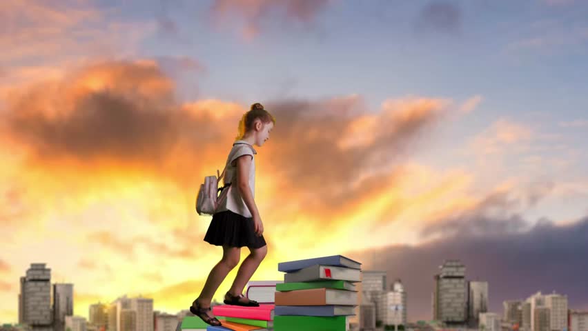 A young schoolgirl climbs to the top of a mountain made of colorful books. Schoolgirl high in the sky painted with sunset colors. Concept of education and adventure. Developing imagination.