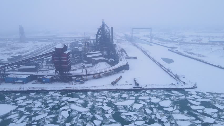 Zug Island steel mill covered in snow with frozen Detroit River