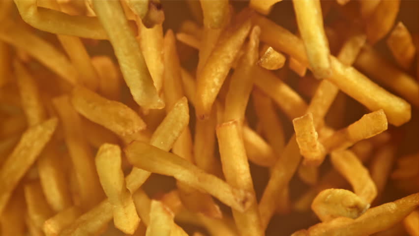 French fries fly up and fall down. Filmed on a high-speed camera at 1000 fps. High quality FullHD footage