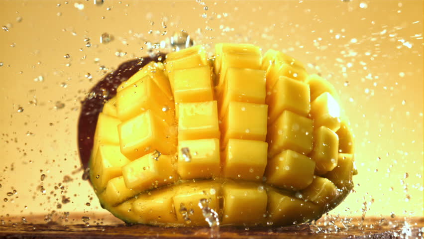 Raindrops fall on fresh mango. Filmed on a high-speed camera at 1000 fps. High quality FullHD footage
