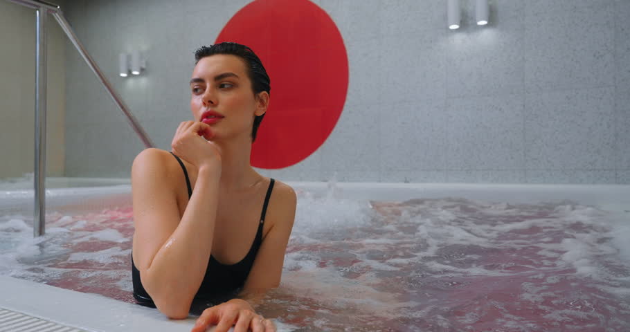 Beautiful Brunette Woman In Black Swimsuit Relaxing In Luxury Spa Or Fitness Center