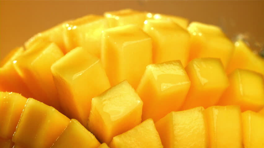 Raindrops fall on fresh mango. Filmed on a high-speed camera at 1000 fps. High quality FullHD footage