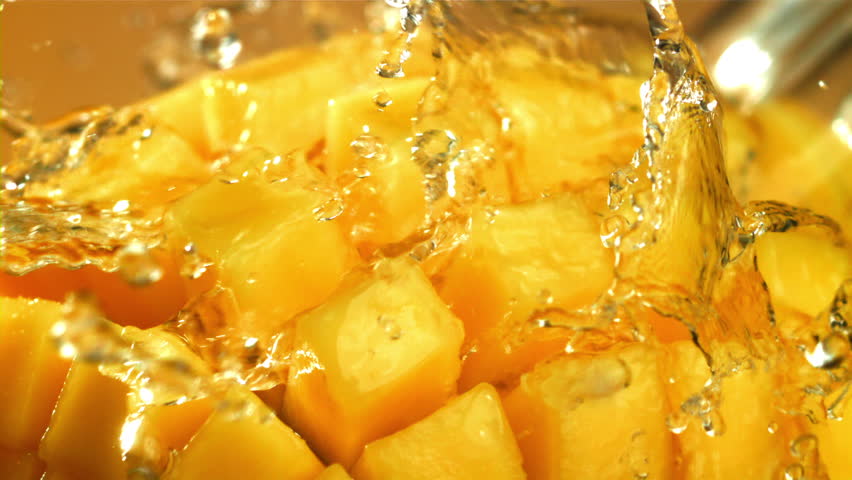 Raindrops fall on fresh mango. Filmed on a high-speed camera at 1000 fps. High quality FullHD footage