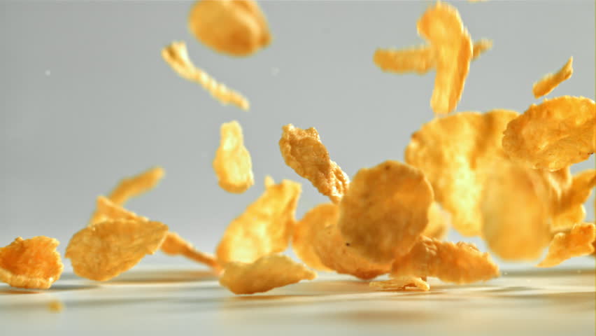 Corn flakes falling on white background. Filmed on a high-speed camera at 1000 fps. High quality FullHD footage