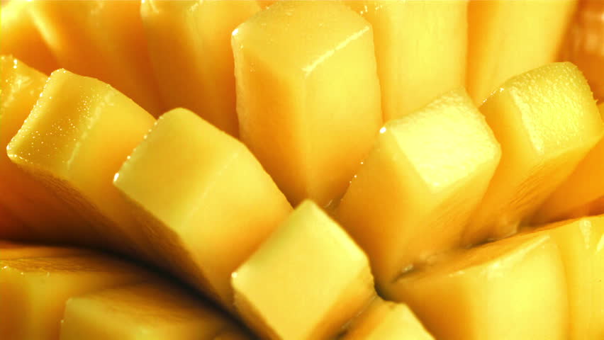 The juice flows through the sliced mango fruit. Filmed on a high-speed camera at 1000 fps. High quality FullHD footage