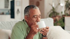 Home, hot coffee and senior man on sofa, relax and blowing with espresso, morning and retirement. Pensioner, apartment and elderly person on couch, herbal tea and warm drink with wellness in lounge - Powered by Shutterstock - Get 15% off with code: PIKWIZARD15