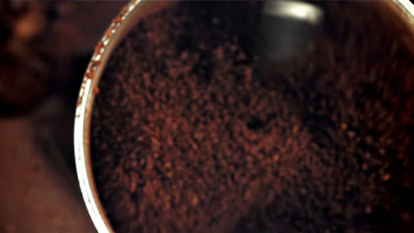 A working grinder with ground coffee. Top view. Filmed on a high-speed camera at 1000 fps. High quality FullHD footage