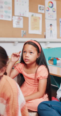 Singing, learning and girl on floor of classroom for education, nursery rhyme and growth. Knowledge, assessment and listening with group of students at school for child development, lesson or future