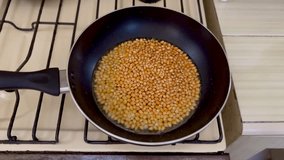 Popcorn kernels being cooked in a pan.  - Powered by Shutterstock - Get 15% off with code: PIKWIZARD15
