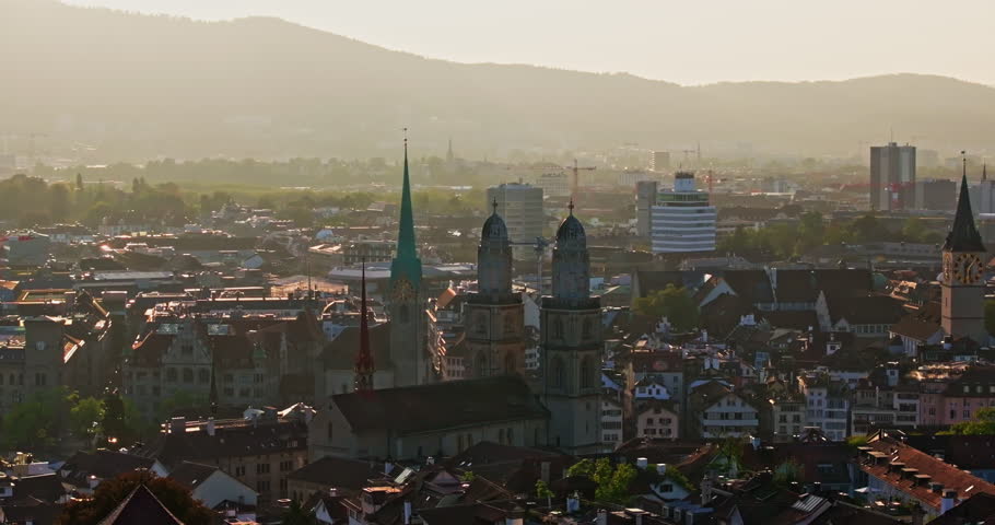 Golden summer sunset over Zürich, captured by drone with stunning views of the city, lake, river, and iconic churches.