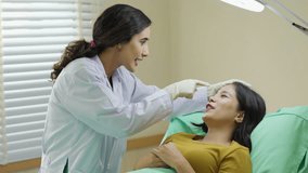 Facial aesthetics surgery treatment : Plastic (Cosmetic) Surgery Center :  Brazilian hispanic female Doctor preparing Asian female patient for cosmetic surgery in clinic - Powered by Shutterstock - Get 15% off with code: PIKWIZARD15