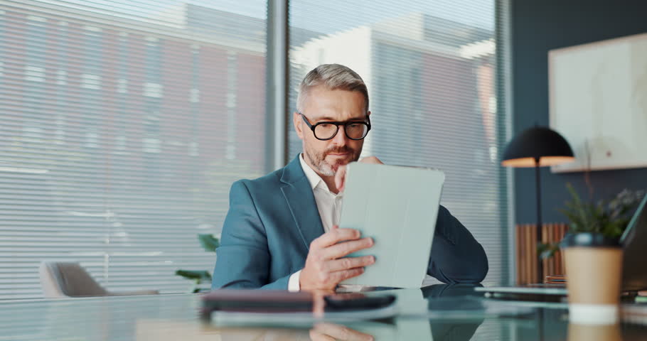 Business, man and reading on tablet in office for financial report, budget planning and information. Thinking, accountant and digital for problem solving, proposal ideas and decision for investment