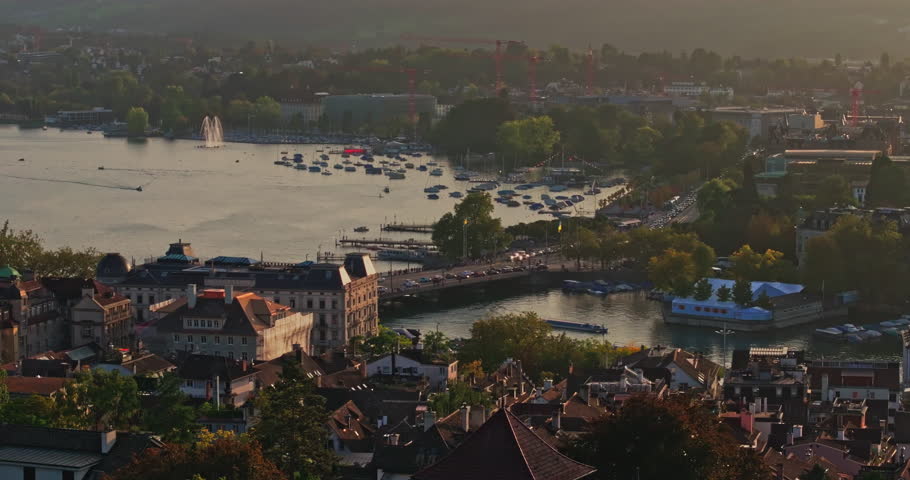 Golden summer sunset over Zürich, captured by drone with stunning views of the city, lake, river, and iconic churches.