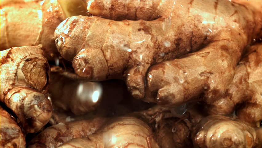 Drops of water fall on fresh ginger. Filmed on a high-speed camera at 1000 fps. High quality FullHD footage