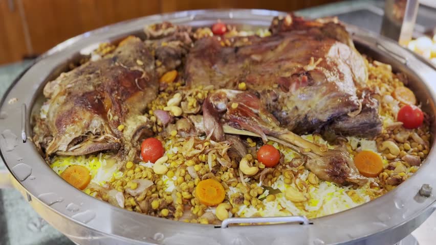 Delicious 4K close-up of Arabic lamb mandi served with fragrant rice, chickpeas, vegetables, and roasted nuts—ideal for food blogs, cultural cuisine, and buffet promos.