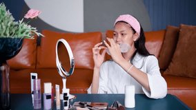 Beautiful young asian woman applying sheet facial mask and looking mirror at home, Girl applying cosmetic and makeup with skincare face for wrinkle, treatment and moisturizer, health and wellness - Powered by Shutterstock - Get 15% off with code: PIKWIZARD15