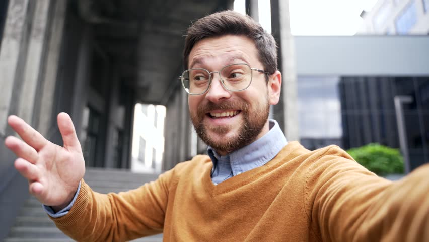 POV Businessman invites you to join team by video call using phone near entrance to business office building. Employer, hr entrepreneur, an investor calls to invest or hiring look at camera. Join Us