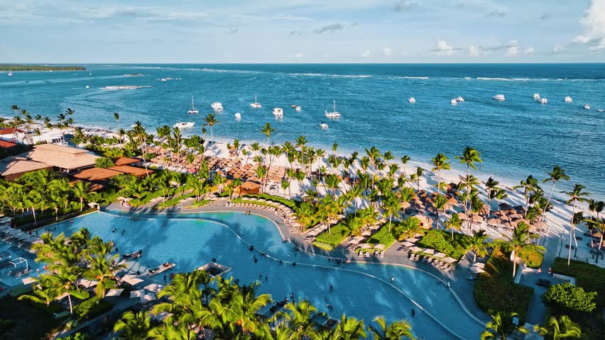 Aerial luxury resort, holiday landscape, resort hotel pool, holiday background. Summer vacation at luxury resort with idyllic beach. Aerial video footage of vacation spot with swimming pool.