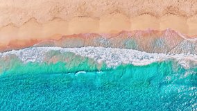 Turquoise sea waves with white foam on yellow sand, drone view. Tropical sea beach background. Calm wave with sunlight reflection. Ocean beach at high tide. - Powered by Shutterstock - Get 15% off with code: PIKWIZARD15