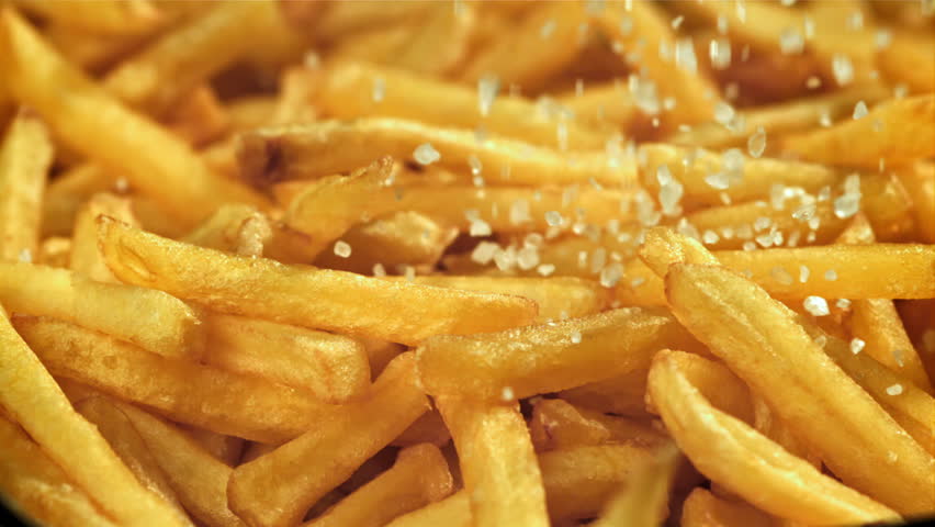 Salt falls on the french fries. Filmed on a high-speed camera at 1000 fps. High quality FullHD footage