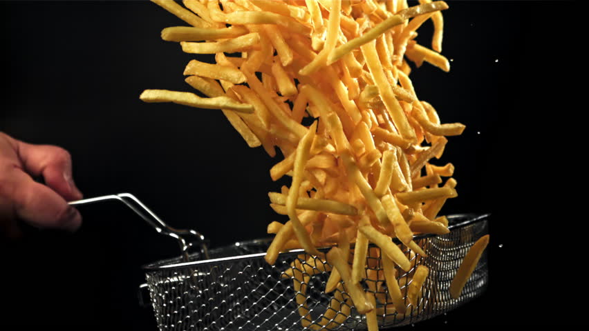 French fries in a deep-frying net in the chef's hand. Filmed on a high-speed camera at 1000 fps. High quality FullHD footage