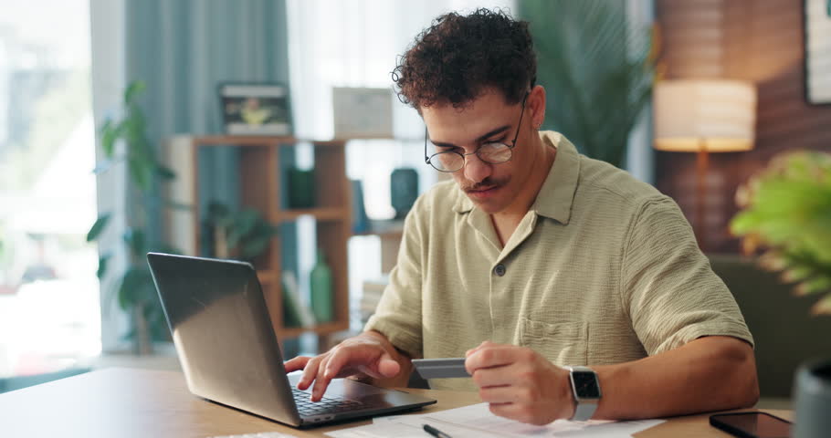 Home, man and typing with laptop for credit card, online shopping and transaction for payment. Office, male person and bills with digital for debit information, ecommerce and banking with happiness