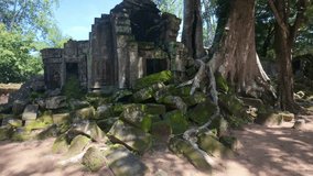 The image depicts moss-covered ruins being overtaken by large tree roots, reflecting the powerful growth of nature in an ancient, overgrown structure. Siem Reap Tomb Raider , Banteay Kdei Temple 
 - Powered by Shutterstock - Get 15% off with code: PIKWIZARD15