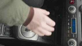 top down view of driver pulling down hand brake lever then shifting gear lever into neutral position on center console inside vehicle cabin under daylight safe parking routine with close detail - Powered by Shutterstock - Get 15% off with code: PIKWIZARD15