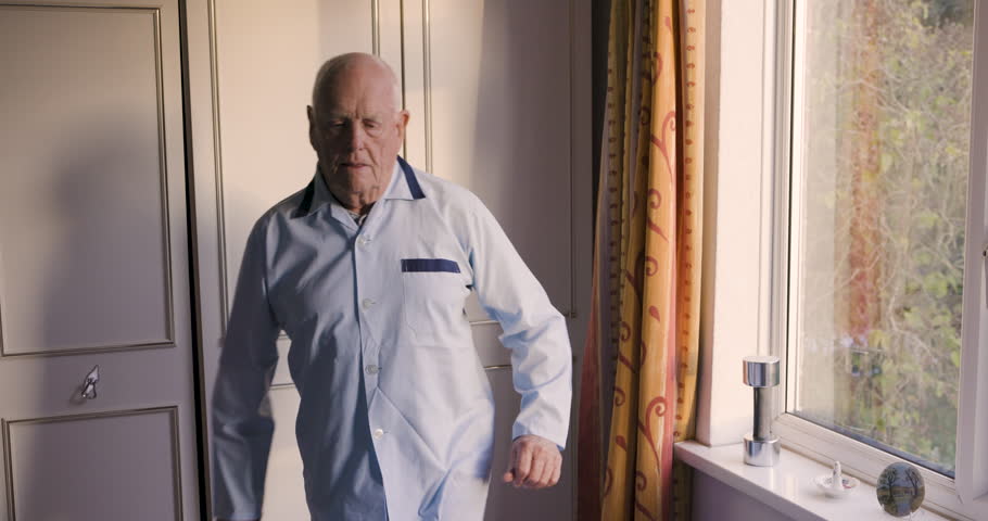 Old man, bedroom and stretching legs in morning, rehabilitation and mobility exercise for healthy lifestyle, fitness and physiotherapy. Senior male in home, body muscle movement and active retirement