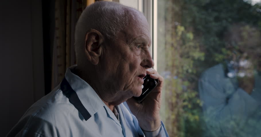 Phone call, window or senior man in retirement for communication, networking or conversation with social network. Elderly, cellphone or male with smartphone for insurance or medical with advisor