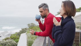 Couple sipping coffee on balcony while marketing team overlaying floating heart and laugh icons. Romantic, lifestyle, minimalist, coastal, candid, emotional, scenic - Powered by Shutterstock - Get 15% off with code: PIKWIZARD15