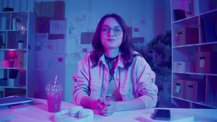 Social Media, Content Creation, Visual Identity. Woman Sits in Neon Home Studio and Records Her Vlog. Bright Personal Space and Digital Presence for Gen Z Online Communication