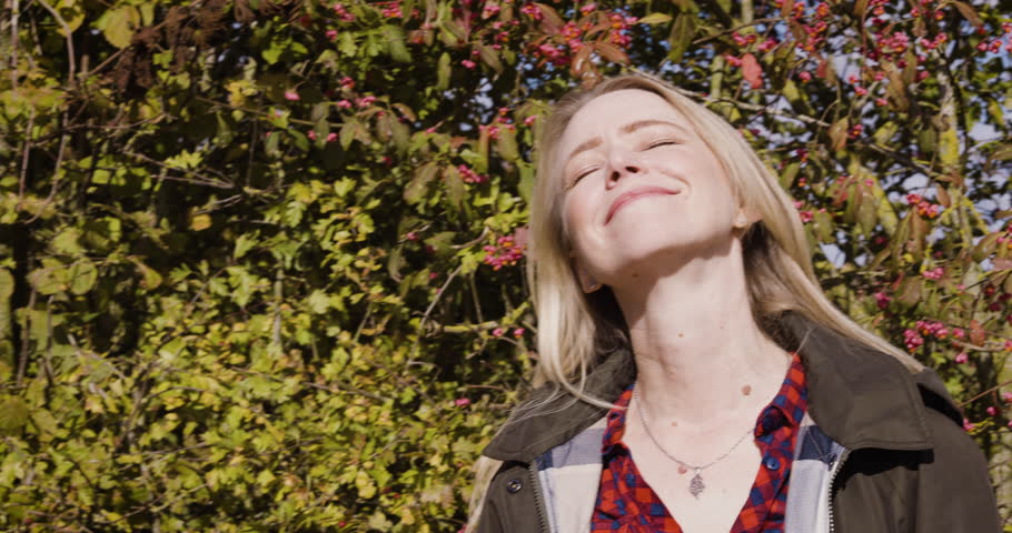 Woman, travel and smile in relax for nature, fresh air or sunshine getting vitamin D by countryside. Happy female traveler smiling in joyful happiness for calm, freedom or natural environment