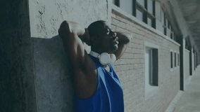 man leaning against concrete wall during urban fitness tech demo, showing digital data overlays. Athlete, urban, modern, energetic, technology, fitness, experimental - Powered by Shutterstock - Get 15% off with code: PIKWIZARD15