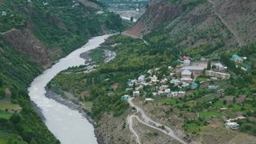 4K Aerial shot of beautiful small village near Chenab river flowing in Lahaul, Himachal Pradesh, India. River flowing in mountain valley. Summer in Himalayas. - Powered by Shutterstock - Get 15% off with code: PIKWIZARD15