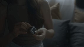 Close-up shot of young Caucasian woman with long hair lighting match near boyfriend and blowing it out, creating intimate atmosphere at home - Powered by Shutterstock - Get 15% off with code: PIKWIZARD15