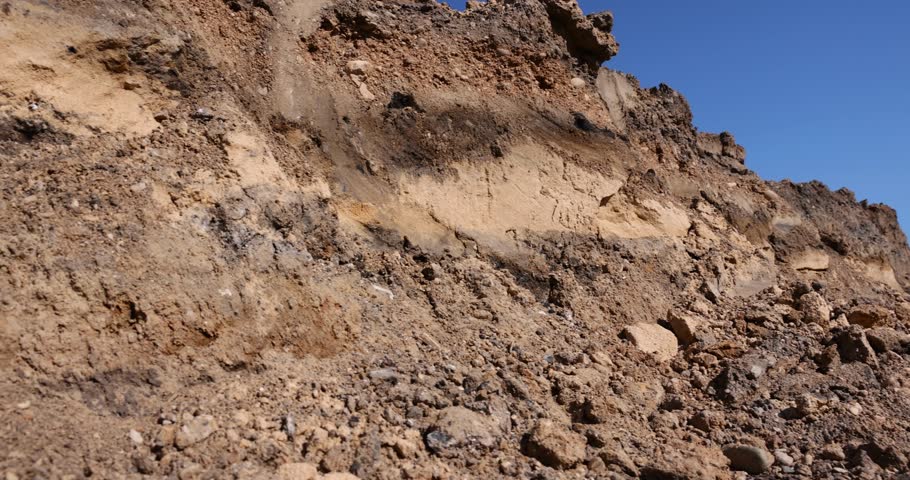 a deep hole in the ground on the site of which a road was started, close up