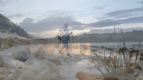 senior woman hiking on rocky beach, with animated health graph and heart icon floating. Outdoor, adventure, scenic, resilience, exploration, wellness, landscape - Powered by Shutterstock - Get 15% off with code: PIKWIZARD15