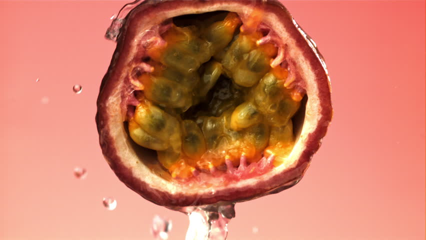 Raindrops fall on tropical passion fruit. Filmed on a high-speed camera at 1000 fps. High quality FullHD footage