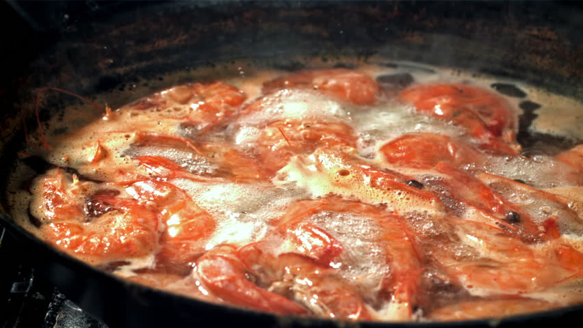 The shrimps fall with splashes into the boiling water. Filmed on a high-speed camera at 1000 fps. High quality FullHD footage