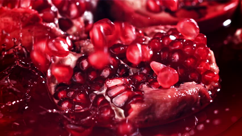 Pomegranate seeds fall into the juice. Filmed on a high-speed camera at 1000 fps. High quality FullHD footage