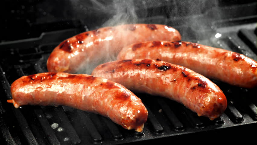 Sausages are fried with splashes in a pan. Filmed on a high-speed camera at 1000 fps. High quality FullHD footage