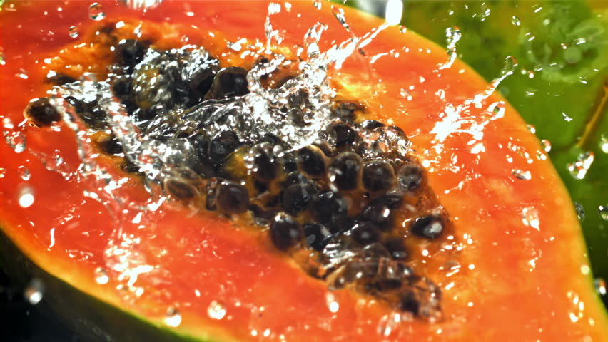 Fresh tropical papaya with drops and splashes of water. Filmed on a high-speed camera at 1000 fps. High quality FullHD footage