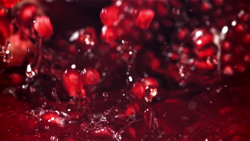 Pomegranate seeds fall into the juice. Filmed on a high-speed camera at 1000 fps. High quality FullHD footage